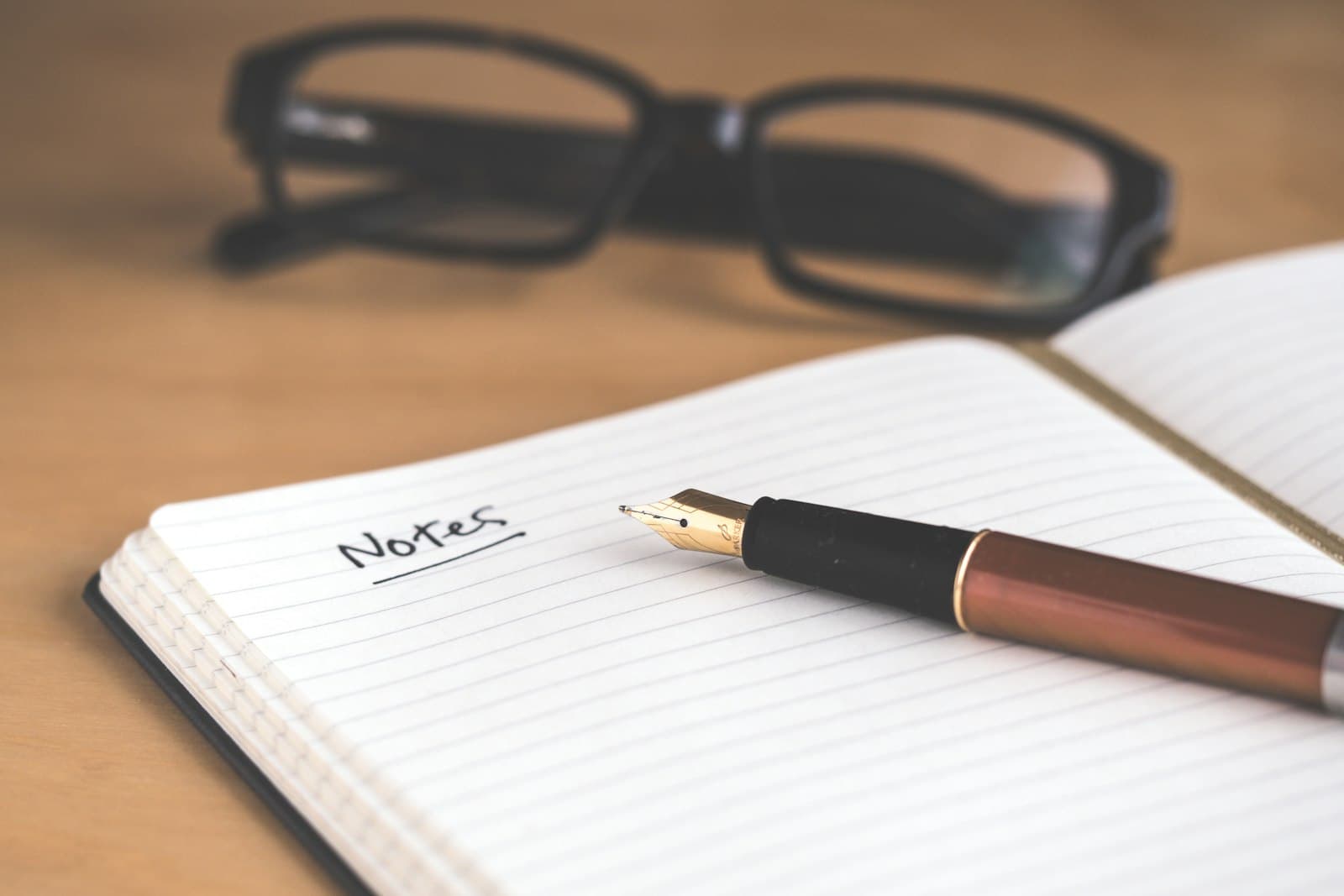 A fountain pen resting on a student's notebook